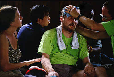 JOE SLOWINSKI, 4 HOURS AFTER BEING 
BITTEN BY A POISONOUS KRAIT SNAKE, 
SURROUNDED BY COLLEAGUES AND FRIENDS, 
BURMA